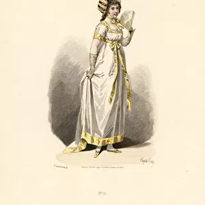 Woman in white dress with yellow trim with fan