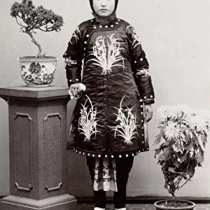 Young Chunese woman, ornate robe, bound feet, China