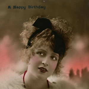 Young woman in white fur on a birthday postcard