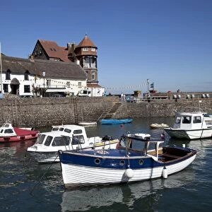 Small fishing boats in Lynmouth harbour with - Rhenish tower in background North Devon UK
