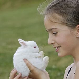 Young Girl - holding white Polish rabbit with red eyes