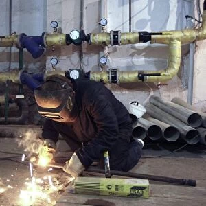 Plumber arc welding pipes