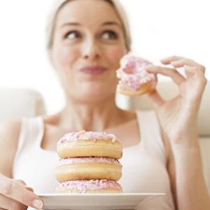Pregnant woman eating doughnuts