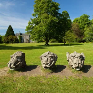 England. Northumberland, Wallington Hall. Carved stone dragon heads in the gardens of Wallington Hall, a National Trust property located in the north