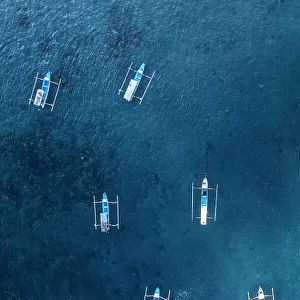 Aeria view of traditional empty fishing boats in the blue water of Gili Trawangan, Gili Islands, West Nusa Tenggara, Pacific Ocean, Indonesia, Southeast Asia Asia