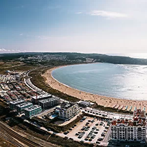Aerial drone panoramic view of Sao Martinho do Porto bay, shaped like a scallop with calm waters and fine white sand, Oeste, Portugal, Europe