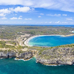 Aerial panoramic by drone of cliffs surrounding Half Moon Bay washed by Caribbean Sea