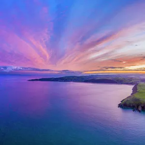 Aerial sunrise view over Baggy Point towards Woolacombe, Morte Bay, North Devon, England