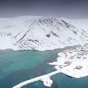 Aerial view of mountains and sea surrounding Sorvaer after a snow blizzard, Soroya Island