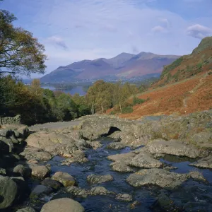 Ashness Bridge over river running into Derwent Water, with Skiddaw behind