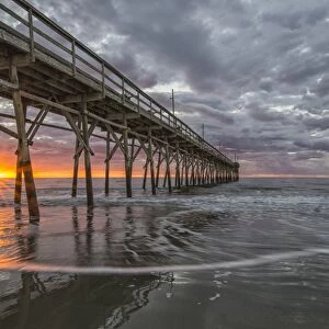 Beach, ocean, waves and pier at sunrise, Sunset Beach, North Carolina, United States of America