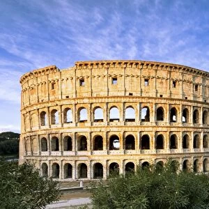 Blue sky at sunrise frames the ancient Colosseum (Flavian Amphitheatre), UNESCO World Heritage Site