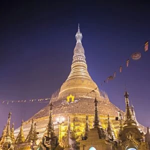 Buddhist monk at Shwedagon Pagoda (Shwedagon Zedi Daw) (Golden Pagoda) at night, Yangon (Rangoon)