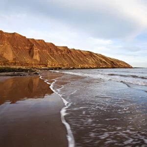 Carr Naze reflected on the wet sands, Filey Brigg, Filey, North Yorkshire, Yorkshire, England, United Kingdom, Europe