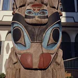 Close-up of painted carving on a totem pole in Thunderbird Park, Victoria