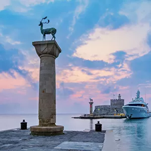 Deer and Doe on columns at the entrance to Mandraki Harbour, former Colossus of Rhodes location, Saint Nicholas Fortress in the background, sunrise, Rhodes City, Rhodes Island, Dodecanese, Greek Islands, Greece, Europe