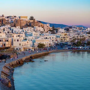 Dusk over Naxos town and causeway to The Porta Gateway, part of the unfinished Temple of Apollo, Naxos, the Cyclades, Aegean Sea, Greek Islands, Greece, Europe