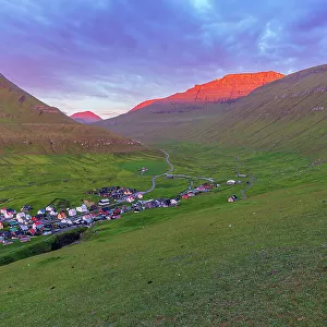Early morning on Gjogv village with the mountain peaks lit by the sun, Eysturoy island, Faroe islands, Denmark, Europe
