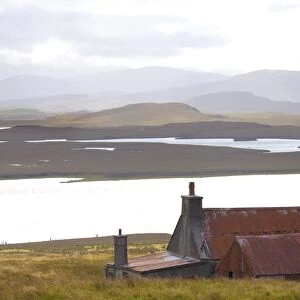 Farmhouse with red iron roof overlooking lochs and mountains off the A858 south of Carloway, Isle of Lewis, Outer Hebrides, Scotland, United Kingdom, Europe