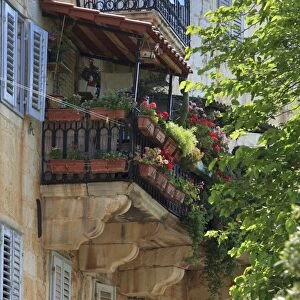 Flower covered balcony on old stone house, Bol, Brac Island, Dalmatian Coast, Croatia, Europe