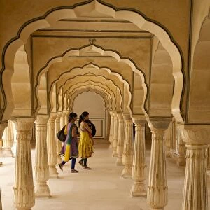 Indian women under arches, Amber Fort Palace, Jaipur, Rajasthan, India, Asia