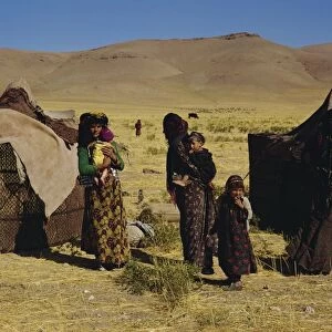 Kurdish family group outside tents