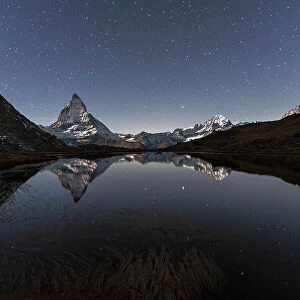 Matterhorn reflection in Riffelsee lake in a starry night, Gornergrat, Zermatt, canton of Valais, Swiss Alps, Switzerland, Europe