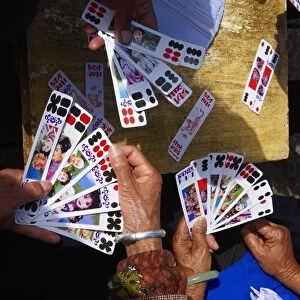 Naxi women playing a local game of cards, Lijiang, Yunnan, China, Asia
