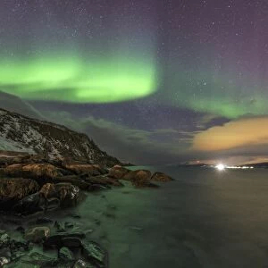 Northern Lights on the icy sea of Svensby, Lyngen Alps, Troms, Lapland, Norway, Scandinavia