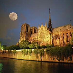 Notre Dame Cathedral at night, with moon rising above, Paris, France, Europe