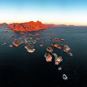 Panoramic aerial view of the fishing village of Henningsvaer and mountains at sunset, Nordland county, Lofoten Islands, Norway, Scandinavia, Europe