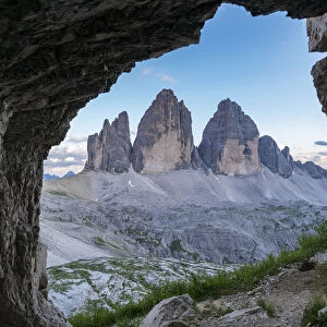 Three Peaks of Lavaredo seen through a rock cave. Sesto Dolomites, Trentino Alto Adige, Italy