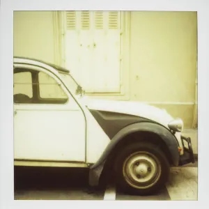 Polaroid of old black and white Citroen 2CV parked on street, Paris, France, Europe