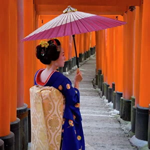 Portrait of a geisha holding an ornate umbrella at