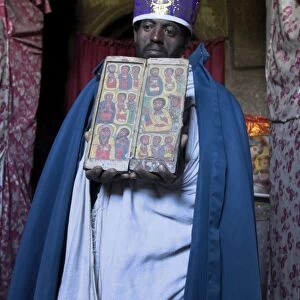 Priest holding ancient manuscript, Ashetan Maryam, Lalibela, Ethiopia, Africa
