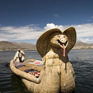 Reed boat with decorative bow, amid floating islands of the Uros people
