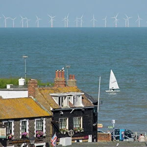 Sailing dinghy passes Broadstairs with Thanet Windfarm in background, Kent, England, United Kingdom, Europe