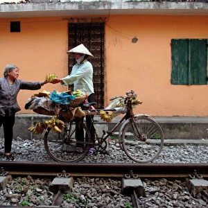 Selling bananas by the railway tracks in central Hanoi