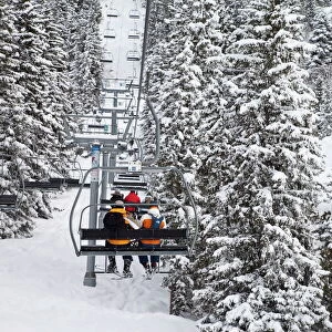 Skiers on a chairlift, Meribel ski resort in the Three Valleys (Les Trois Vallees)