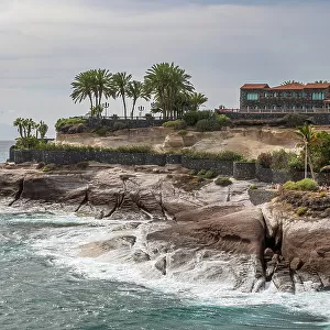 Spectacular coastline of Costa Adeja, with the Atlantic Ocean crashing against the rocky headland, and exotic palm trees, Tenerife, Canary Islands, Spain, Atlantic Ocean, Europe