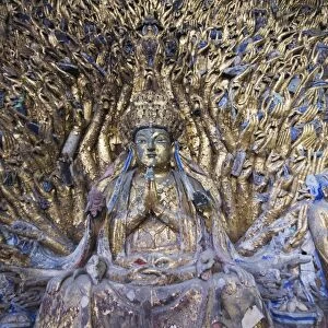 Statue of Avalokitesvara with One Thousand Arms has 1007 arms at the Dazu Buddhist rock sculptures