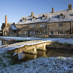 Stone bridge and Cotswold cottages in snow, Lower Slaughter, Cotswolds, Gloucestershire