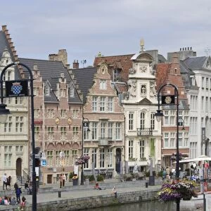 Students relaxing along the banks of the Graslei, Baroque style Flemish gables in the background, Ghent, Belgium, Europe