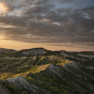 Sunset above badlands and countryside with colored clouds in the sky, Bologna, Emilia Romagna, Italy, Europe