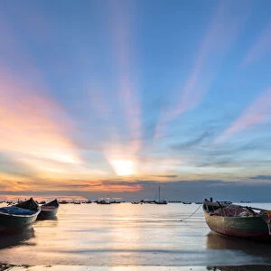 Sunset from Front beach, Vung Tau with pink clouds and small fishing boats in the