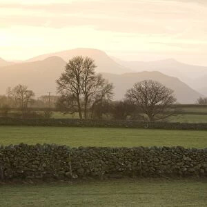 Sunset over Lakeland Fells with fields and stone walls, near Keswick, Lake District National Park