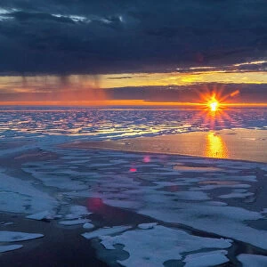 Sunset and rain showers in the heavy pack ice in McClintock Channel, Northwest Passage, Nunavut, Canada, North America