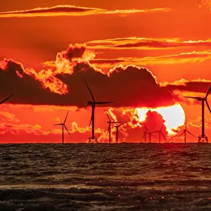 Sunset view towards the distant Walney Offshore wind farm from Walney Island on the Cumbrian Coast, Furness Peninsula, Cumbria, England, United Kingdom, Europe