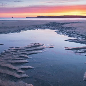Tidal pools on a deserted sandy beach at sunrise, Harlyn Bay, Cornwall, England, United Kingdom, Europe