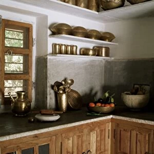 Traditional brass kitchen utensils in kitchen area